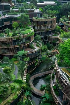 an aerial view of several circular buildings surrounded by trees and greenery in the city