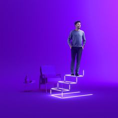 a man standing on top of a set of stairs in front of a purple background