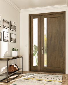 a living room with two doors and pictures on the wall above it, along with a coffee table