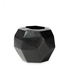 a black vase sitting on top of a white table