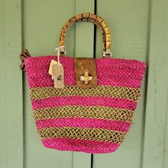 This Is A Lovely Magenta And Natural Raffia Tote From Caribbean Joe. It Has A Green Fabric Lining, With 2 Slips And A Zippered Pocket. It Fastens With A Zip Top With Two Tassels. It Also Has A Turnlock Toggle Size: Length: 17" At The Widest Point. 11": At The Bottom. Height: 14.5" Depth: 6: Handle Drop: 6.5" Condition: New With Tags. The Green Fabric Is A Little Discolored At The Top. Pink Beach Bag With Leather Handles, Pink Straw Tote Bag With Leather Handles, Pink Straw Tote Bag, Pink Straw Bag With Leather Handles For Shopping, Pink Straw Beach Bag For Everyday Use, Pink Bag With Bamboo Handle For Everyday Use, Pink Everyday Bag With Bamboo Handle, Pink Travel Bag With Bamboo Handle, Pink Straw Bag With Leather Handles For Everyday