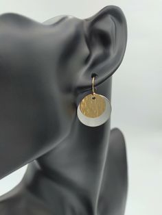 Add two or more items to your cart and enter the code: MOREMETAL during checkout for 15% off of your whole order! These incredibly elegant handmade disc earrings are made from .999 fine silver and 14k gold filled metal. 14k gold filled means that 5% of the metal used in making each gold piece is made from 14k gold which has been bonded with a base metal. This gives the wearer the advantages of wearing 14k gold without the cost. The fine silver has a brushed finish which contrasts nicely with the hammered texture of the gold from each pair of earrings. The silver disc of each earring measures at 7/8 inches in size, or nearly a full inch in diameter. The smaller gold disc measures 5/8 inches in diameter. Finishing off each of these earrings is a 14k gold filled ear wire along with a hypoalle Modern Round Earrings For Gifts, Modern Round Pendant Earrings As Gift, Elegant Metal Round Disc Earrings, Hammered Round Disc Earrings As Gift, Hammered Round Disc Earrings For Gift, Elegant Silver Disc Earrings, Nickel-free Metal Round Disc Earrings, Modern Nickel-free Round Disc Earrings, Elegant Nickel Free Round Disc Earrings