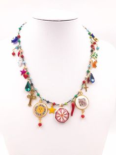 the necklace is decorated with colorful beads and charms on it's neckpieces