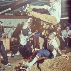 a group of young men standing next to each other on top of a skateboard ramp