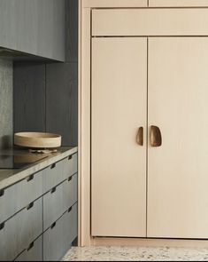 a kitchen with wooden cabinets and granite counter tops, along with a bowl on the counter