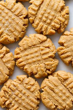 peanut butter cookies are arranged on a white surface