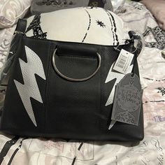 The Lightning Bolt Girls Purse Is A Trendy And Versatile Accessory Designed With A Touch Of Edginess. Measuring 12 X 8 Inches, It Offers Ample Space For Your Essentials. The Purse Is Adorned With Striking Lightning Bolt Motifs In Black And Silver, Creating A Bold And Stylish Look. It Features Both Metal Handles For A Chic Handheld Option And An Adjustable Shoulder Strap, Providing Flexibility In How You Carry It. This Purse Is The Perfect Blend Of Fashion And Functionality, Making It A Must-Have Black Lightening, Fringe Crossbody Purse, Rebecca Minkoff Crossbody Bag, Frankie Stein, Kipling Bags, Faux Leather Purse, The Lightning, Faux Leather Bag, Girls Purse