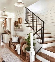 a living room filled with furniture next to a stair case