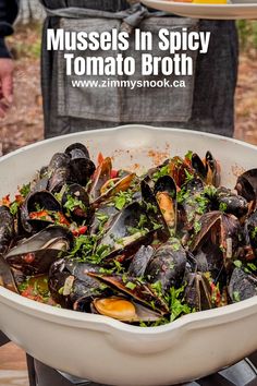 mussels in spicy tomato broth on an outdoor grill, with text overlay reading mussels in spicy tomato broth