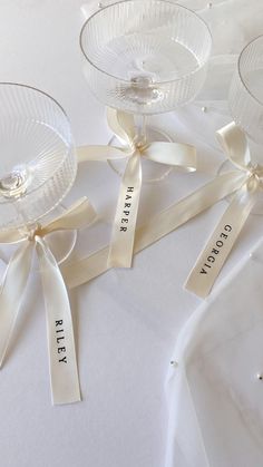 three glass dishes with ribbons tied around them