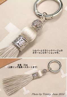 the keychain has a tassel on it and is decorated with crystal beads