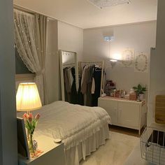 a bed room with a neatly made bed next to a dresser and a mirror on the wall