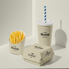 two takeout boxes with french fries and a drink