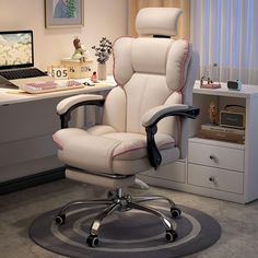 a white office chair sitting in front of a desk with a laptop computer on it