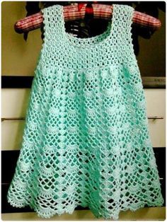 a green dress hanging on a clothes rack