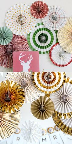 paper fans are hanging on the wall with gold and green decorations around them, as if for christmas or new year's eve