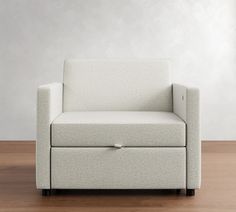 a white couch sitting on top of a hard wood floor