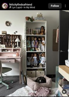 a room filled with lots of dolls and toys on top of bookshelves next to a desk