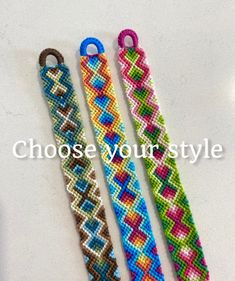 three different colored bracelets on a table