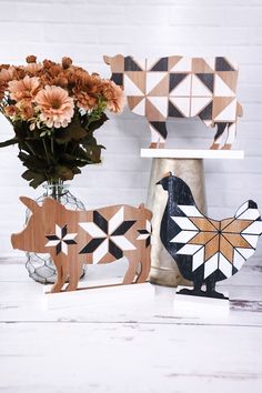 three vases with flowers in them sitting next to each other on a white table