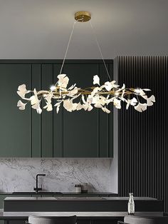 a modern chandelier hanging over a kitchen counter