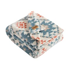 three blankets stacked on top of each other in blue, orange and white geometric designs