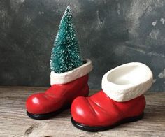 a pair of red rubber boots with a green christmas tree in the boot on top