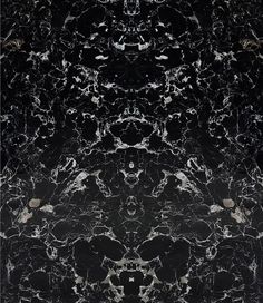 a black and white marble wallpaper with an intricate design in the center, as well as circles