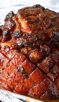 some kind of meat sitting on top of a foil pan covered in bbq sauce