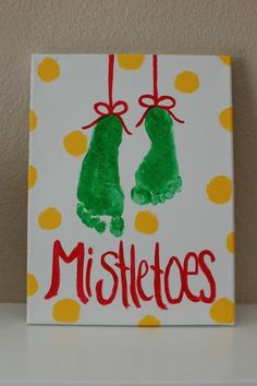 a handprinted sign with two green mittens hanging from it's sides