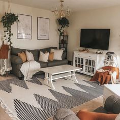 a living room filled with furniture and a flat screen tv