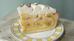 a slice of banana cream pie on a yellow and white plate with a brown border