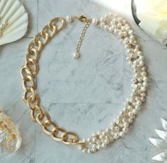 "A Hammered Chain of Twist Links in Gold Color Connects to A Cultured Freshwater Pearl Hoop Necklace Length: 18\" L. Extender: 2\" L Cultured freshwater 6-7MM/ gold plated aluminum chain. Vermeil 12MM lobster clasp and extender. Hand strung, beaded, and crafted." Adjustable White Pearl Necklace With Chain, White Adjustable Pearl Necklace, White Pearl Necklace With Chain, White Pearl Necklace Chain For Jewelry Making, White Round Chain Necklace With Lobster Clasp, White Chain Necklace With Lobster Clasp, Hoop Necklace, Diy Friendship Bracelets Patterns, Curb Chain Necklace