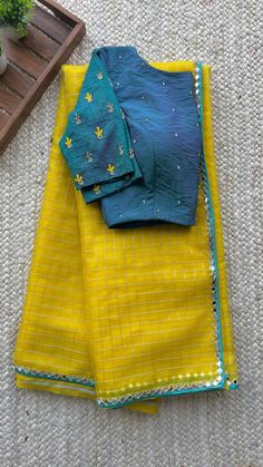 Product Descriptions : Yellow organza checked designer saree having mirror embroidery border works is paired up with sea blue silk embroidery hand worked blouse.     View this post on Instagram A post shared by threadslabel.com (@shobana_nithin) Checked Saree, Hand Worked Blouse, Worked Blouse, Checks Saree, Simple Saree Designs, Embroidery Border