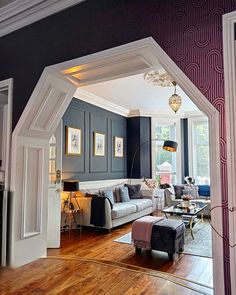 a living room filled with furniture and a wooden floor