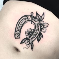 a woman's stomach with a tattoo design on it