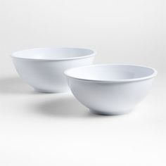 two white bowls sitting next to each other