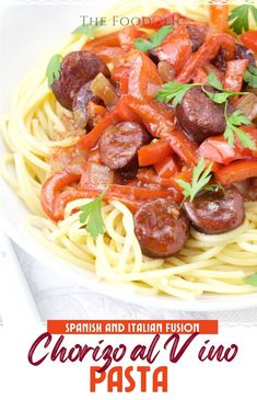 a plate of pasta with sausage and tomato sauce