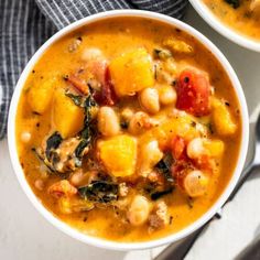 two bowls filled with soup on top of a table