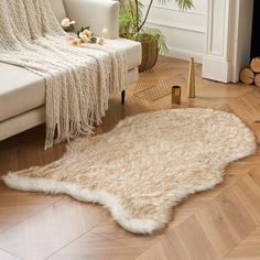 a living room with a white couch and rug