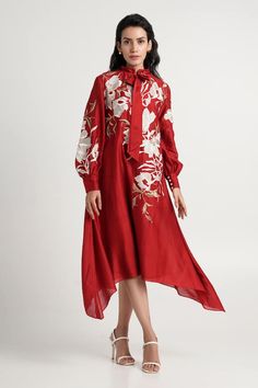 Red midi dress with floral resham embroidery, neck tie-up and asymmetric hem. - Aza Fashions Festive Long Sleeve Floral Midi Dress, Chic Floral Print Festive Dress, Chic Festive Floral Print Dresses, Festive Chic Floral Print Dresses, Red Floral Embroidered A-line Dress, Elegant Silk Midi Dress With Floral Embroidery, Spring Red Silk Dress, Chic Silk Festive Dress, Red Silk Dress For Spring