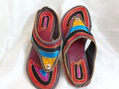 Bohemian shoes, colourful women's sandals from Punjab: Fashion footwear for the contemporary city dweller, from five centuries back. Mumtaz, the lady for whom the Taj Mahal was built probably lived in shoes and sandals much like these. Originally meant for the Maharajahs and the Maharanis [Kings and Queens and such royalty], these handcrafted fashion footwear for men and women mainly come from the villages of Punjab and Rajasthan. This period fashion piece was introduced to India during the Mugh Festive Sandals With Gota Work For Diwali, Festive Closed Toe Sandals With Gota Work, Festive Sandals With Gota Work And Single Toe Strap, Traditional Closed Toe Sandals For Festive Occasions, Flat Sandals For Diwali, Traditional Sandals For Diwali Festival, Flat Sandals For Festive Diwali, Flat Sandals For Festive Diwali Celebrations, Festive Multicolor Flat Sandals