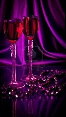 two glasses of wine on a purple background