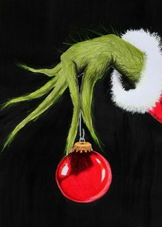 a painting of an ornament hanging from a string with the grin face painted on it