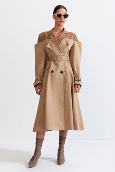 Nude Double Combined Trench Coat This Double Combined Trench Coat is perfect for any season. The fitted waistline flaunts your figure and the wide padded shoulders create a flattering silhouette. It features a mid-calf length and a unique combination of a trench coat with a blazer style. It has front buttons for closur Spring Fitted Outerwear With Structured Shoulders, Spring Outerwear With Structured Shoulders, Fall Outerwear With Structured Shoulders, Fitted Gabardine Belted Outerwear, Knee-length Outerwear With Hidden Button Closure For Spring, Spring Knee-length Outerwear With Hidden Button Closure, Fitted Beige Outerwear With Belted Cuffs, Fitted Gabardine Outerwear For Office, Midi Length Winter Outerwear For Work