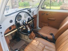 the interior of an old car with brown leather seats