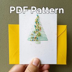 a hand holding up a card with a christmas tree on it and the text, pdf pattern