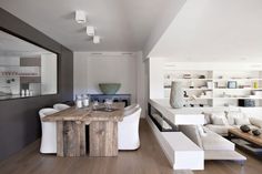 a living room filled with furniture and a wooden table in front of a white couch