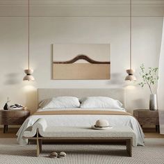 a white bed sitting in a bedroom next to two lamps and a painting on the wall