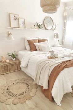 a bedroom with white walls and wooden flooring is decorated in neutral tones, such as beiges and browns